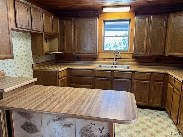 kitchen featuring sink and wood ceiling