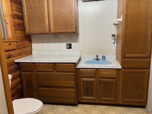 kitchen with sink and log walls