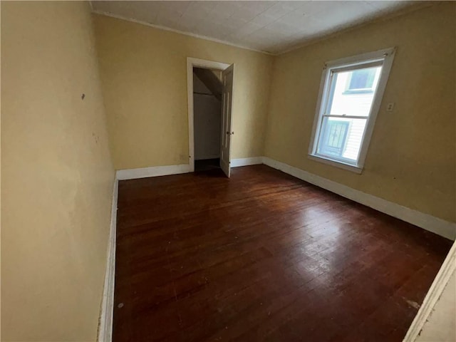 unfurnished room with dark hardwood / wood-style flooring