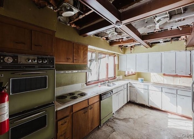 kitchen featuring light countertops, under cabinet range hood, stainless steel dishwasher, and white cooktop