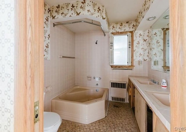 full bathroom featuring tile walls, radiator, toilet, a bath, and a sink