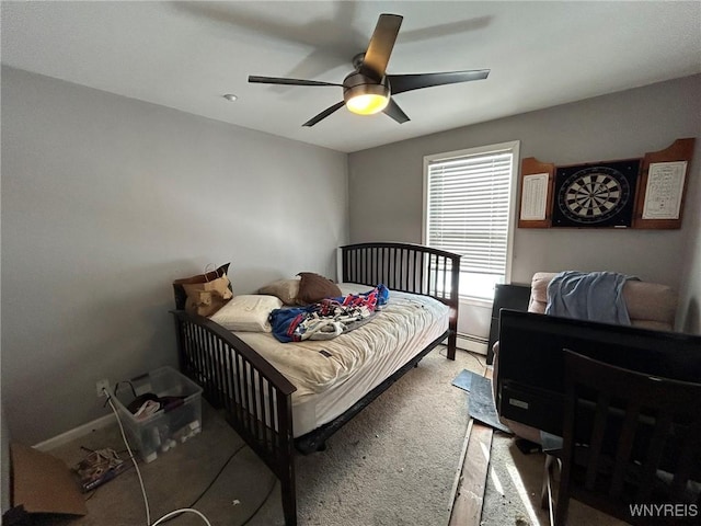 bedroom with baseboard heating, ceiling fan, and carpet floors