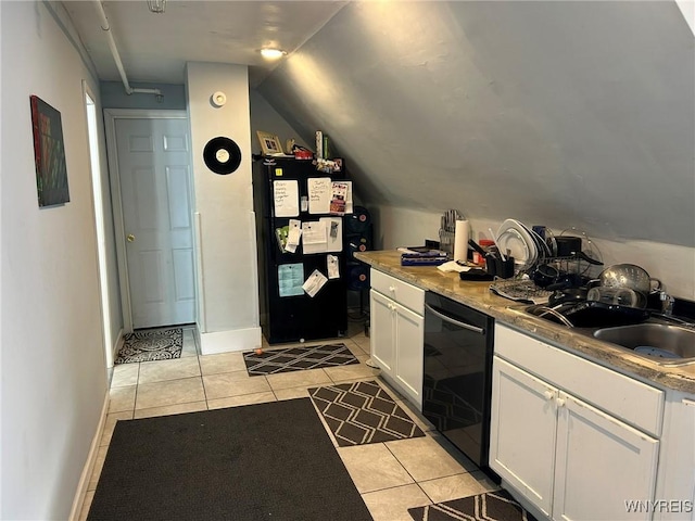 kitchen featuring lofted ceiling, sink, light tile patterned floors, black appliances, and white cabinets