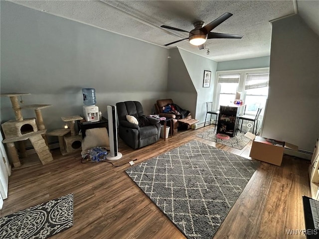 bonus room with ceiling fan, dark wood-type flooring, a baseboard radiator, and a textured ceiling