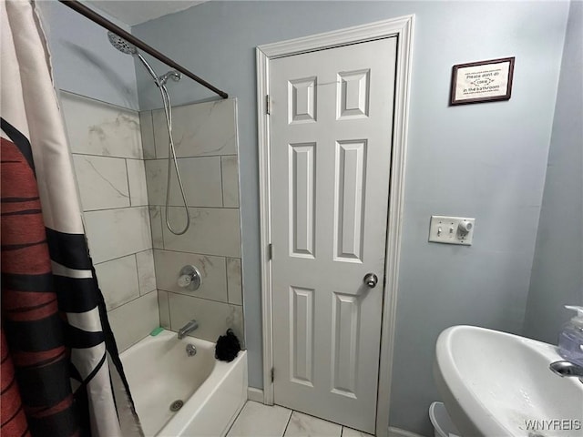 bathroom with sink and shower / bath combo with shower curtain