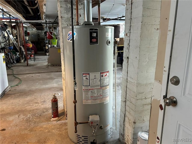 utility room featuring water heater