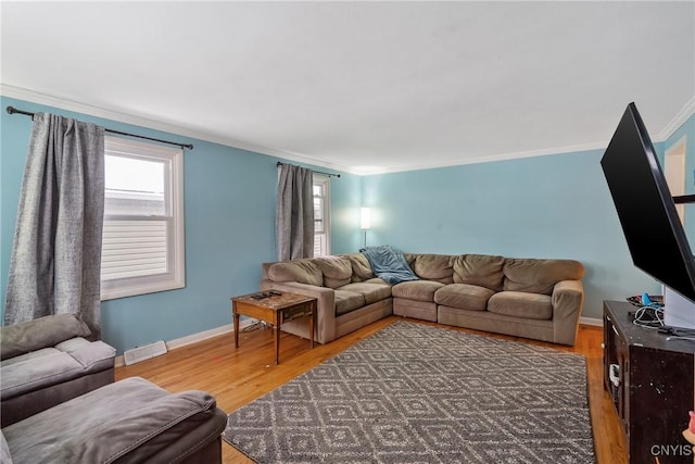 living room featuring crown molding, plenty of natural light, and wood-type flooring