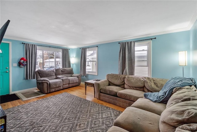 living room with hardwood / wood-style flooring and crown molding