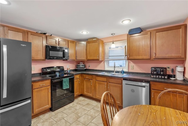 kitchen featuring sink, pendant lighting, and black appliances