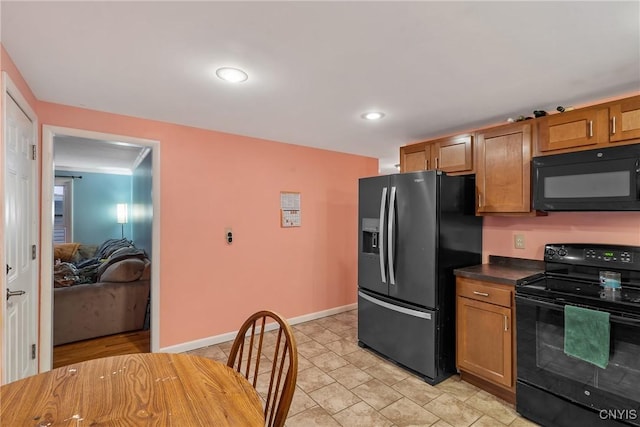 kitchen featuring ornamental molding and black appliances