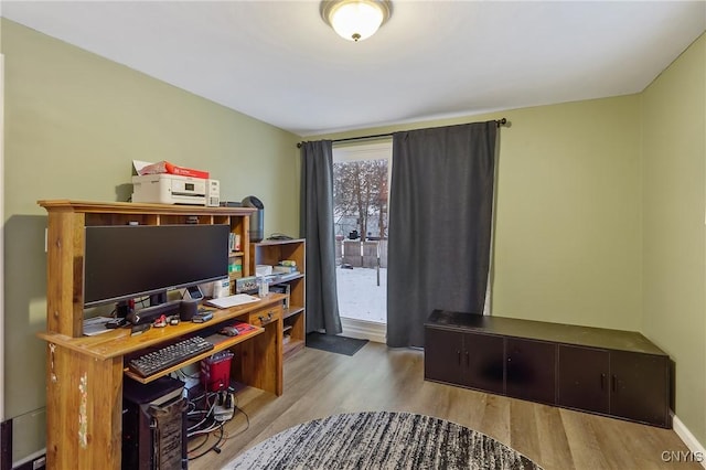 home office with light hardwood / wood-style floors