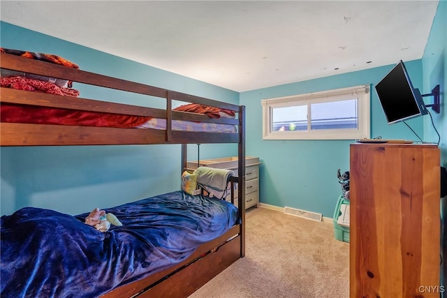 bedroom featuring light carpet