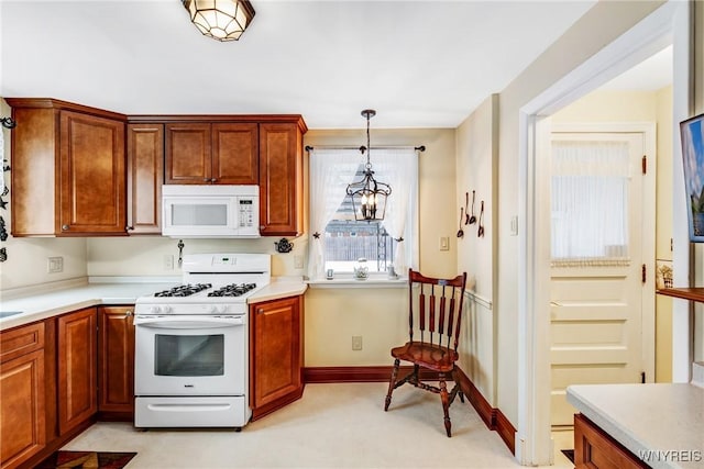 kitchen featuring white appliances and decorative light fixtures