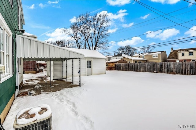 yard covered in snow featuring an outdoor structure and cooling unit