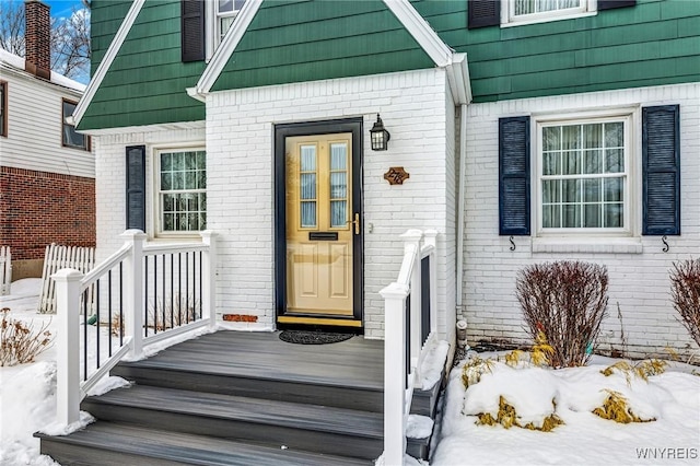 view of snow covered property entrance