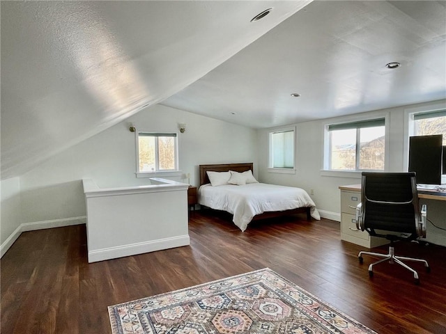 bedroom featuring lofted ceiling, dark hardwood / wood-style floors, and multiple windows