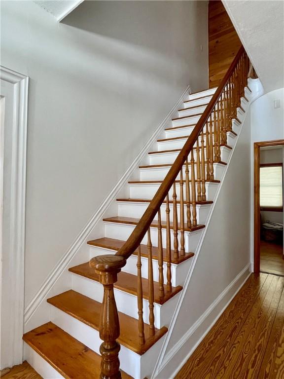 stairs with hardwood / wood-style flooring