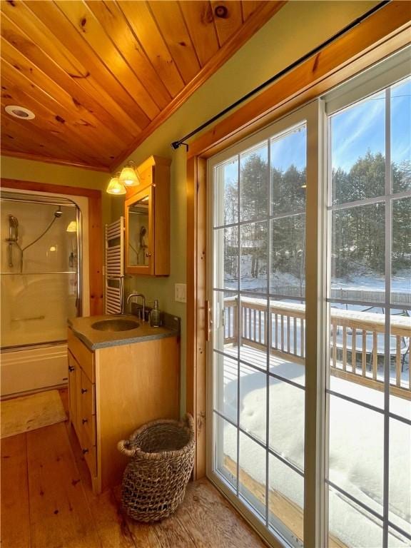 doorway with sink, radiator, wood ceiling, and light hardwood / wood-style flooring