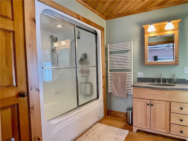 bathroom with bath / shower combo with glass door, radiator heating unit, hardwood / wood-style flooring, vanity, and wood ceiling