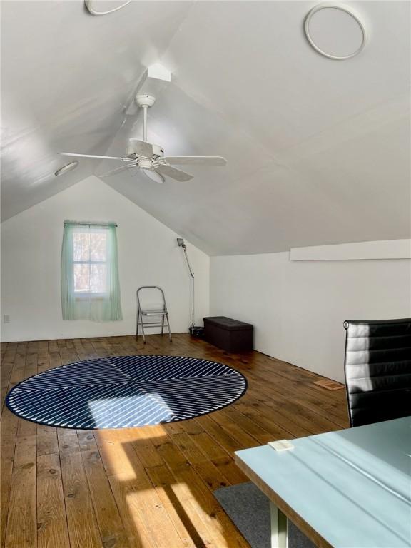 bonus room with wood-type flooring, lofted ceiling, and ceiling fan