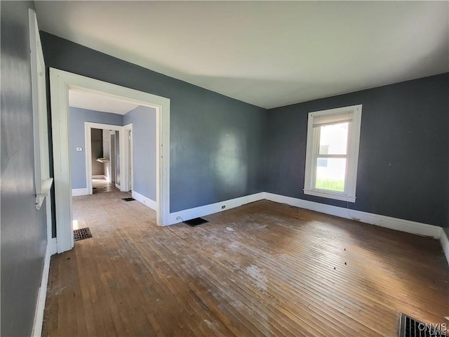 spare room featuring wood-type flooring