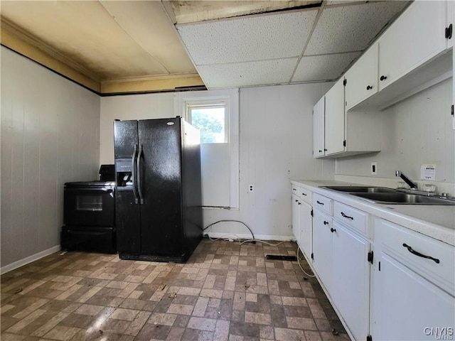 kitchen with sink, crown molding, a paneled ceiling, white cabinetry, and black appliances