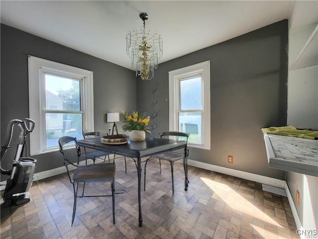 dining area featuring plenty of natural light and a chandelier