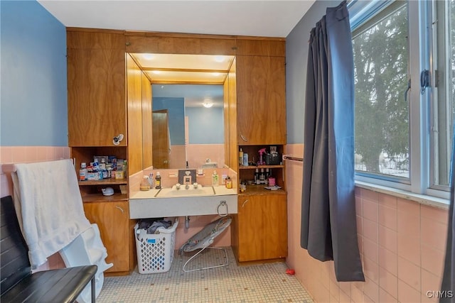 bathroom with tile walls and vanity