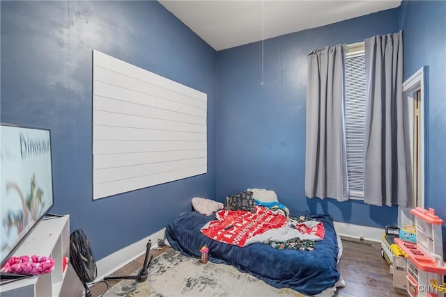 bedroom with dark wood-type flooring