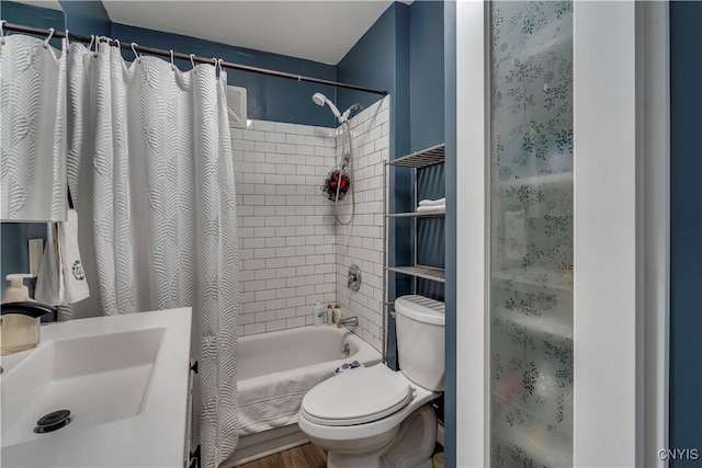 full bathroom with sink, shower / bathtub combination with curtain, and toilet