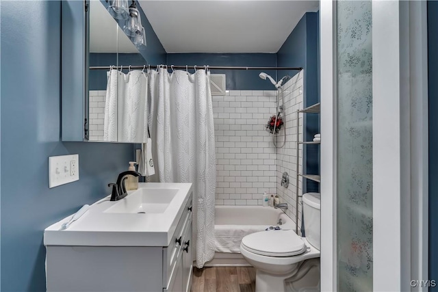 full bathroom with shower / tub combo, vanity, wood-type flooring, and toilet