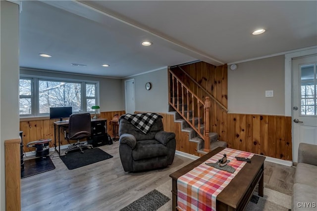 office area featuring hardwood / wood-style flooring, ornamental molding, and wooden walls