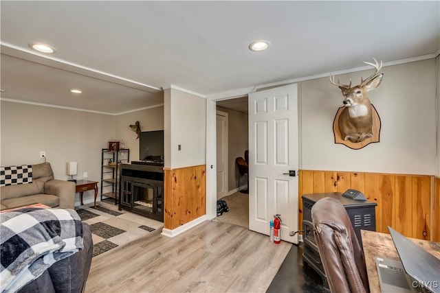 living room featuring ornamental molding and light wood-type flooring