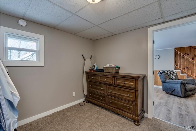 carpeted bedroom with a drop ceiling