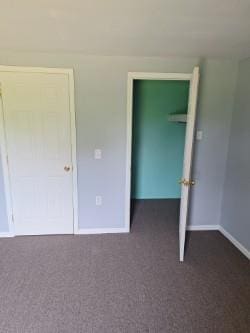 unfurnished bedroom featuring dark colored carpet