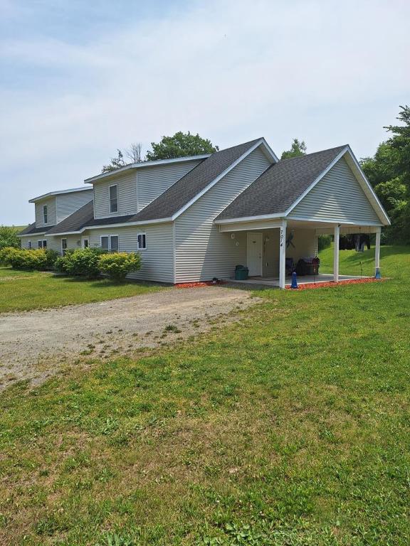 view of front of home with a patio and a front yard