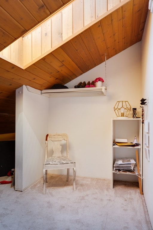 sitting room featuring lofted ceiling, carpet, and wood ceiling