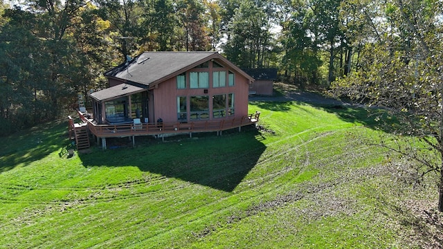 exterior space featuring a lawn and a deck