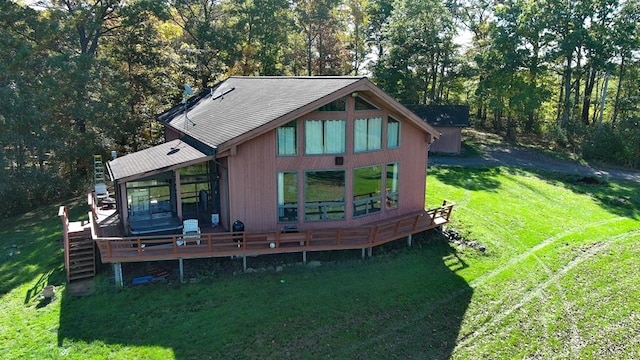 back of house with a wooden deck and a lawn