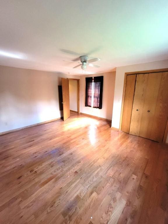 unfurnished bedroom featuring hardwood / wood-style flooring and ceiling fan