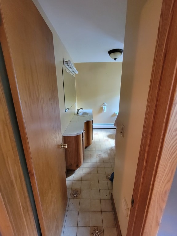 bathroom featuring a baseboard radiator, vanity, and tile patterned flooring