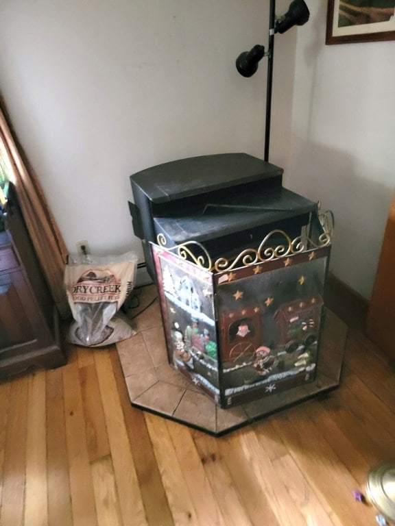 room details featuring hardwood / wood-style flooring and a wood stove