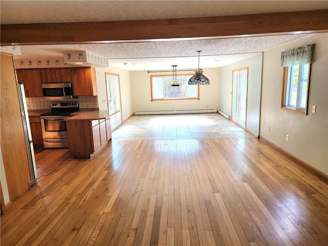 3530 Coats Rd, Hector, NY 14818 - kitchen featuring appliances with stainless steel finishes, beamed ceiling, a baseboard radiator, light wood-style flooring, and healthy amount of natural light