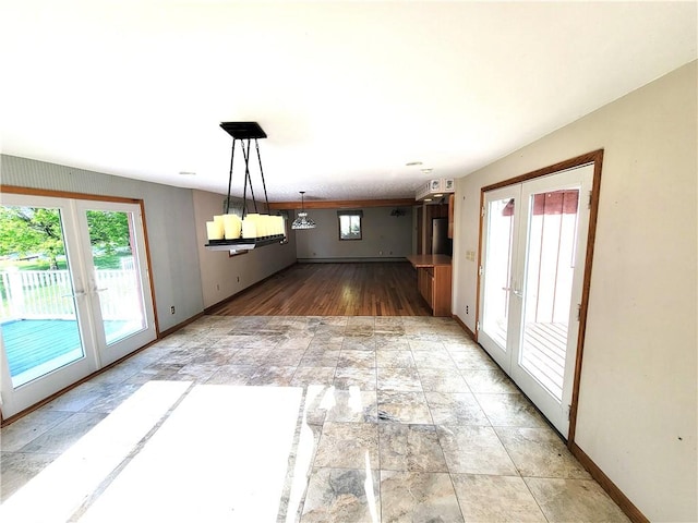 3530 Coats Rd, Hector, NY 14818 - unfurnished dining area featuring french doors, baseboards, and light stone finish floors