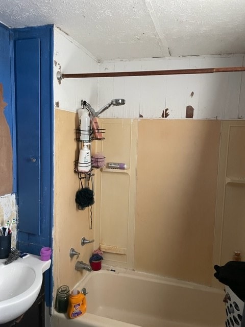 bathroom with  shower combination, a textured ceiling, and vanity