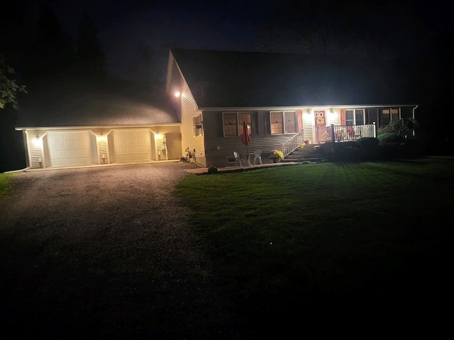 view of front of house featuring a garage and a lawn