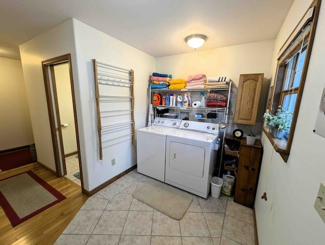 clothes washing area featuring separate washer and dryer and light tile patterned flooring