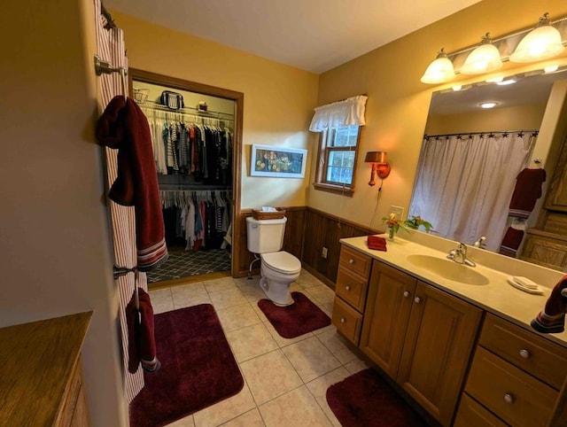 bathroom with tile patterned flooring, vanity, and toilet