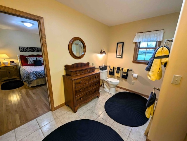 bathroom with toilet and tile patterned flooring