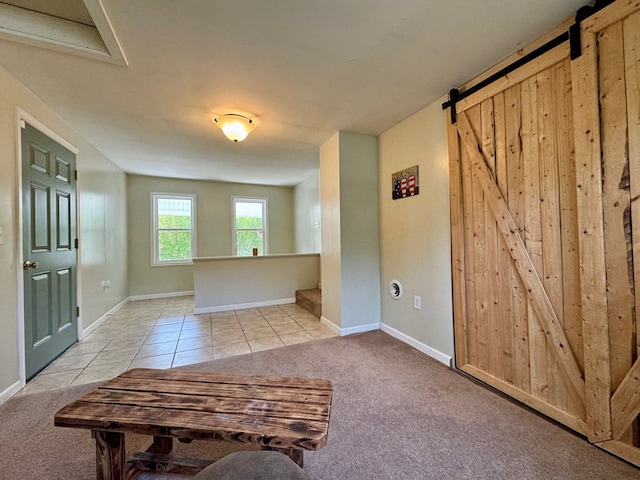 living room with light tile patterned floors and a barn door